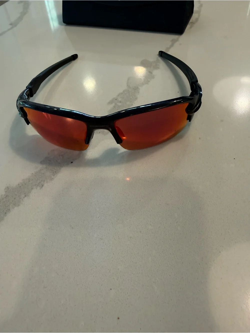Oakley Gloss Black Frame Sunglasses with Red-Orange Mirrored Lenses